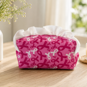 Home Handmade breast cancer awareness cosmetic bag with white ruffle trim, pink ribbon fabric, and zippered closure by Stacy’s Bags.