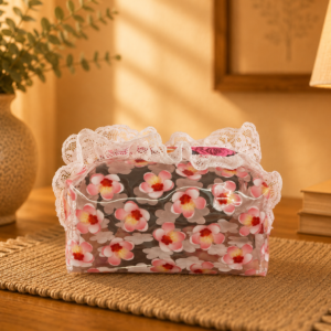 Side view of clear floral vinyl cosmetic bag with colourful rose fabric and white lace
