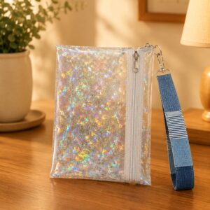 Holographic Shimmer Wristlet with white zipper and blue patchwork wrist strap.