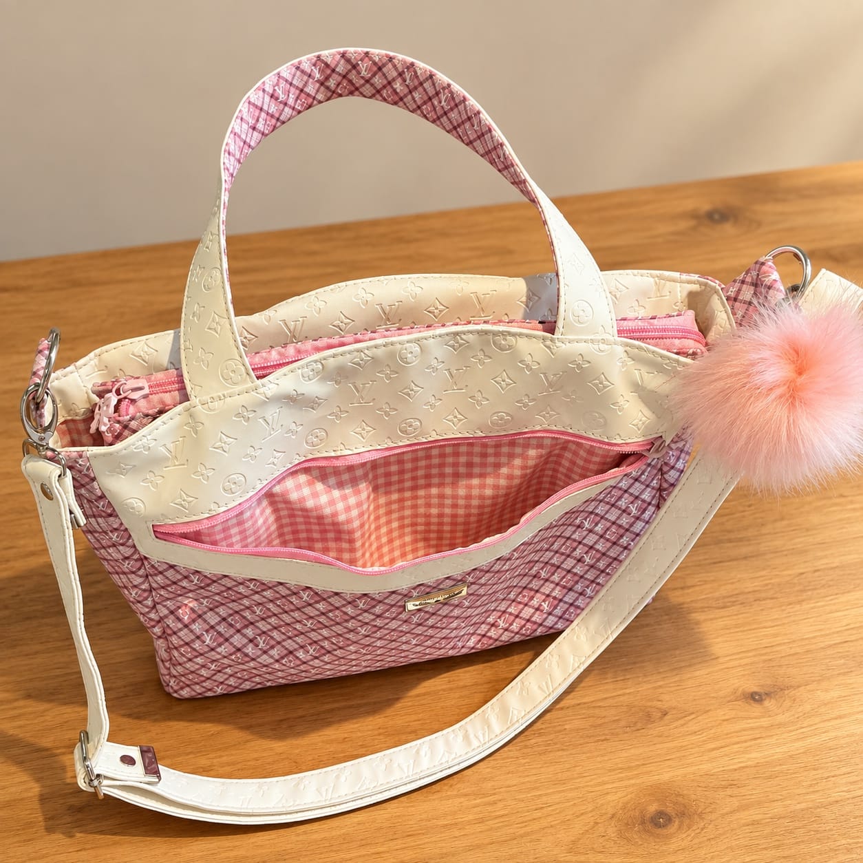 Front zippered pocket opened to show the pink gingham lining on the pink plaid handbag.